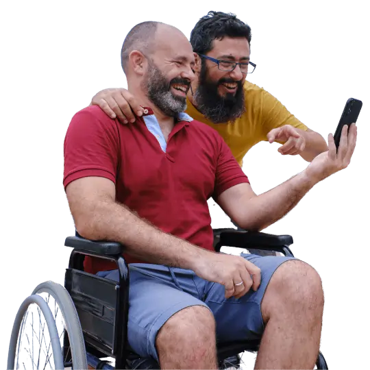 A person in a wheelchair taking a selfie with someone standing beside them.