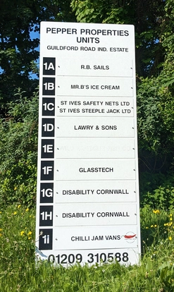 Directory sign for Pepper Properties Units on Guildford Road Industrial Estate, listing businesses including Disability Cornwall.