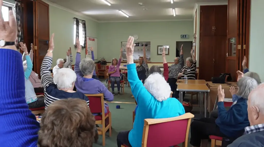 People taking part in a dementia support session in a community room