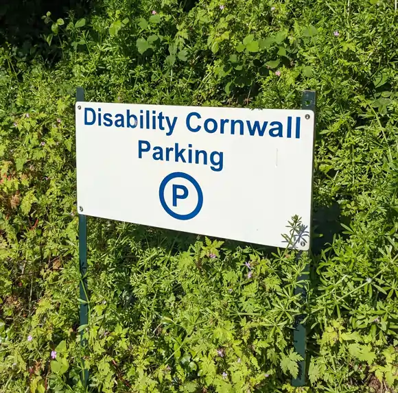 Disability Cornwall parking sign marking reserved parking for visitors at Disability Cornwall premises.